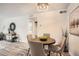 Cozy dining area with a round table, stylish chairs, and modern lighting, perfect for intimate meals at 10211 Ura Ln # 7-204, Thornton, CO 80260