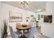 Charming dining area featuring stylish chairs, modern lighting, and elegant wall art at 10211 Ura Ln # 7-204, Thornton, CO 80260