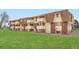 Exterior of the condo building on a grassy lawn at 10211 Ura Ln # 7-204, Thornton, CO 80260