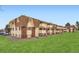 Exterior of the condo building on a grassy lawn at 10211 Ura Ln # 7-204, Thornton, CO 80260