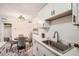 Well-lit kitchen area with modern appliances and a round dining table, great for cooking and dining at 10211 Ura Ln # 7-204, Thornton, CO 80260
