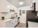 Bright kitchen featuring white cabinets, stainless steel appliances, and sleek countertops at 10211 Ura Ln # 7-204, Thornton, CO 80260