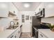 Modern kitchen with stainless steel appliances, white cabinets and updated countertops at 10211 Ura Ln # 7-204, Thornton, CO 80260