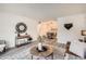 Inviting living room with a dining area, refined decor, and modern gray laminate floors at 10211 Ura Ln # 7-204, Thornton, CO 80260