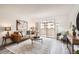 Relaxing living room offering a sliding glass door, comfortable seating, and charming accents at 10211 Ura Ln # 7-204, Thornton, CO 80260