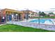 Community pool surrounded by grass and fencing at 10211 Ura Ln # 7-204, Thornton, CO 80260