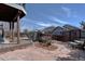 Beautifully landscaped backyard featuring a stone patio and garden area at 11918 S Hitching Post Trl, Parker, CO 80134