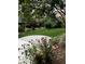 Backyard featuring a well-maintained lawn, garden and mature trees at 11918 S Hitching Post Trl, Parker, CO 80134