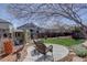 Inviting backyard with a circular patio, shed, and mature landscaping at 11918 S Hitching Post Trl, Parker, CO 80134