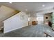 Finished basement features an open living area, stair access, and comfortable seating at 11918 S Hitching Post Trl, Parker, CO 80134