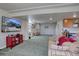 Finished basement with TV and shelving, plus comfortable seating, and neutral decor at 11918 S Hitching Post Trl, Parker, CO 80134