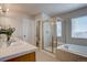 Luxurious bathroom featuring double sinks, a glass shower, and a soaking tub for relaxation at 11918 S Hitching Post Trl, Parker, CO 80134