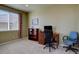 Bedroom features neutral walls, carpet, and a window offering natural light, with desk setup at 11918 S Hitching Post Trl, Parker, CO 80134