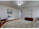 Bright bedroom showcasing a cozy bed, art, and a light fixture, creating a relaxing and inviting space at 11918 S Hitching Post Trl, Parker, CO 80134