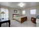 Cozy bedroom with natural light, warm tones, a wooden bed, and a serene atmosphere at 11918 S Hitching Post Trl, Parker, CO 80134
