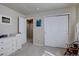 Bright bedroom featuring closet doors, a dresser, artwork, and natural light at 11918 S Hitching Post Trl, Parker, CO 80134
