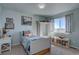 Bright bedroom with a twin bed, shelving, a large window, and a serene, organized atmosphere at 11918 S Hitching Post Trl, Parker, CO 80134