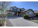 Charming two-story home with a three car garage, stone accents, and well-manicured landscaping at 11918 S Hitching Post Trl, Parker, CO 80134