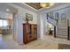Elegant foyer features hardwood floors, staircase, and seamless transition to the kitchen at 11918 S Hitching Post Trl, Parker, CO 80134