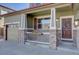 Close up front porch view shows stone accents with updated front door and three car garage at 11918 S Hitching Post Trl, Parker, CO 80134
