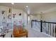 Upstairs hallway with neutral carpet, wood table with decorations, and shelves with decorations at 11918 S Hitching Post Trl, Parker, CO 80134