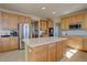 Spacious kitchen features wooden cabinets, stainless steel appliances, and functional center island at 11918 S Hitching Post Trl, Parker, CO 80134