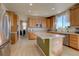 Bright kitchen featuring stainless steel appliances, wood cabinets, and center island with light countertops at 11918 S Hitching Post Trl, Parker, CO 80134