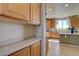 Bright kitchen boasts wooden cabinetry, modern appliances, and seamless flow to the dining area at 11918 S Hitching Post Trl, Parker, CO 80134