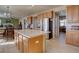 Open-concept kitchen showcases wooden cabinets, modern appliances, and center island with seating at 11918 S Hitching Post Trl, Parker, CO 80134