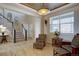 Cozy living room showcases a decorative ceiling, staircase, and plenty of natural light at 11918 S Hitching Post Trl, Parker, CO 80134