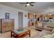 Inviting living room with wood floors adjacent to kitchen features a cabinet and comfortable seating at 11918 S Hitching Post Trl, Parker, CO 80134