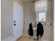 Entryway featuring a white door and coat hooks underneath a window for lots of light at 11918 S Hitching Post Trl, Parker, CO 80134