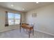 Bright home office featuring a large window, neutral walls, and a wooden desk for a comfortable workspace at 11918 S Hitching Post Trl, Parker, CO 80134
