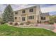 The backyard features a stone patio, bench, and gorgeous landscaping at 18225 E Caley Dr, Aurora, CO 80016