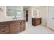 Beautiful bathroom with dual vanity sinks, decorative mirrors, and a glass enclosed shower at 18225 E Caley Dr, Aurora, CO 80016