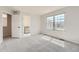 Bright bedroom with large window, plush carpet, and walk-in closet at 18225 E Caley Dr, Aurora, CO 80016