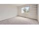 Carpeted bedroom featuring bright natural light and installed shelving at 18225 E Caley Dr, Aurora, CO 80016