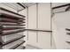 Walk-in closet with ample storage including shelving and drawers at 18225 E Caley Dr, Aurora, CO 80016