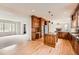 Gourmet kitchen with wood floors, granite countertops, and seamless access to the living room at 18225 E Caley Dr, Aurora, CO 80016