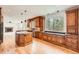 Open-concept kitchen with wood cabinetry, granite countertops, and a clear view to the living area at 18225 E Caley Dr, Aurora, CO 80016