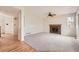 Cozy living room with a classic brick fireplace and neutral carpeting at 18225 E Caley Dr, Aurora, CO 80016