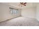 Bright main bedroom with a ceiling fan and a large window with natural light at 18225 E Caley Dr, Aurora, CO 80016