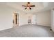 Spacious main bedroom features neutral carpet, ceiling fan, and ensuite bathroom entry at 18225 E Caley Dr, Aurora, CO 80016