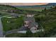 Expansive aerial view of a home surrounded by rolling hills, showcasing its long driveway and spacious layout at 6402 Wauconda Dr, Larkspur, CO 80118