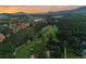 This aerial shot displays a lush golf course winding through a neighborhood in a beautiful valley at 6402 Wauconda Dr, Larkspur, CO 80118