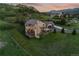 Charming aerial view of a home with stone accents, beautiful landscaping, and private deck area at 6402 Wauconda Dr, Larkspur, CO 80118