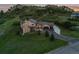 A high angle of a landscaped home with stone accents and an attached three-car garage near a rocky mountain at 6402 Wauconda Dr, Larkspur, CO 80118
