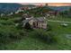 Breathtaking aerial view of a home nestled in the foothills, showcasing lush greenery and scenic mountain views at 6402 Wauconda Dr, Larkspur, CO 80118
