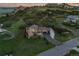 Panoramic aerial view of a home nestled against rocky hillside, highlighting the large garage and well-maintained yard at 6402 Wauconda Dr, Larkspur, CO 80118