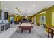 Finished basement featuring a pool table, kitchenette and a cozy living room at 6402 Wauconda Dr, Larkspur, CO 80118